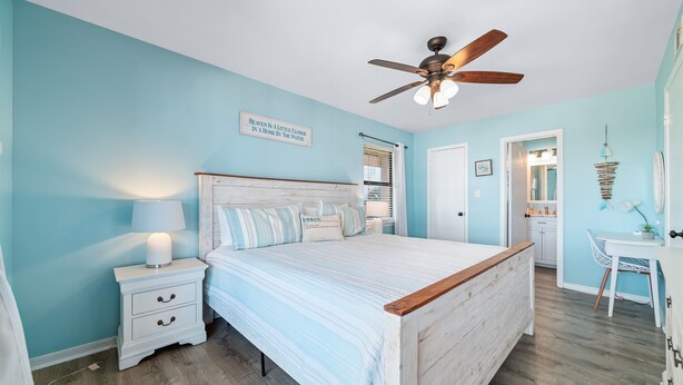 A bedroom with a bed, nightstands, a ceiling fan, and a wall with a quote. - Perfect family stay by Gulf & Lagoon! Dogs welcome (Gulf Shores)