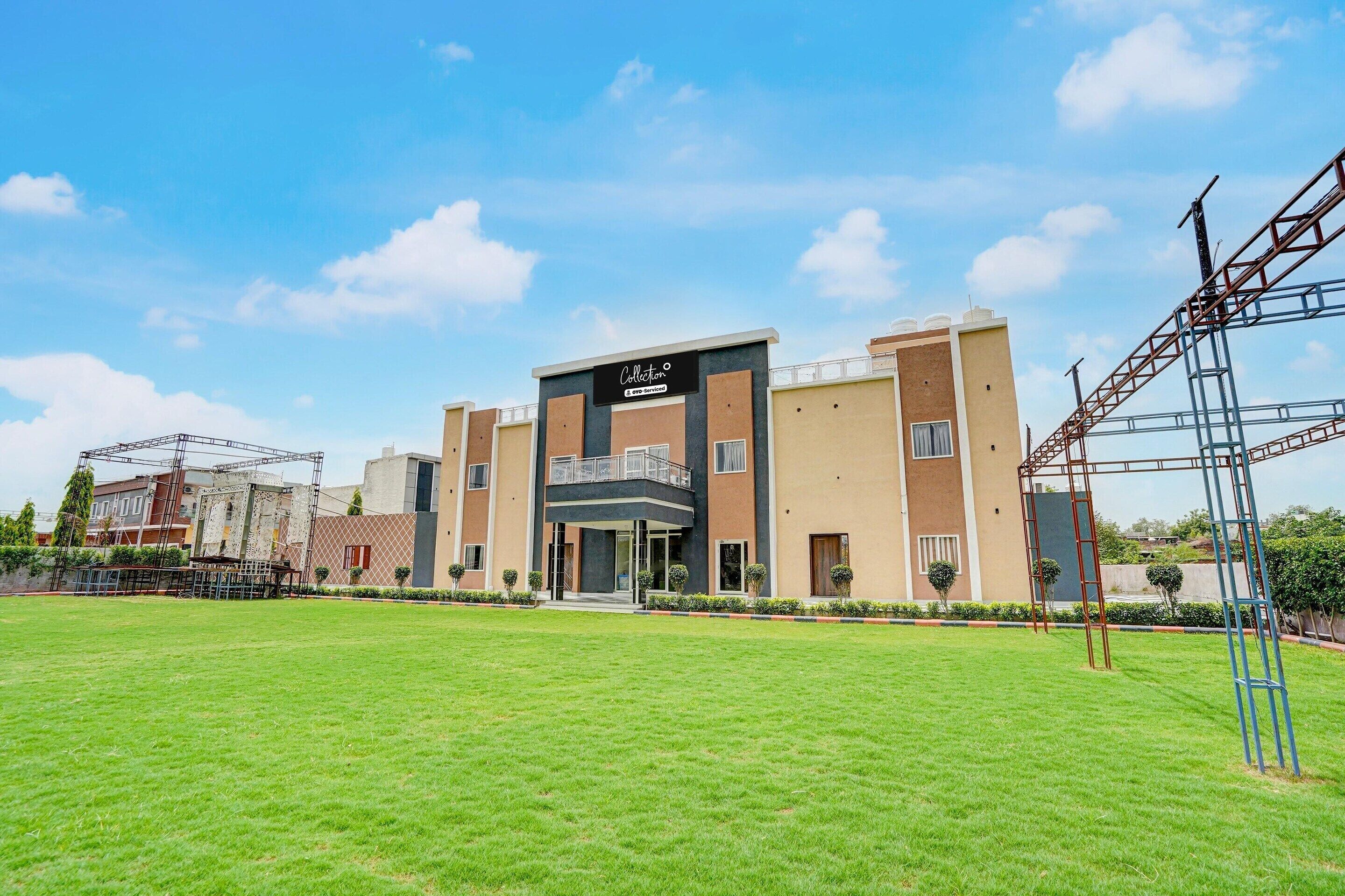 A modern building with a flat roof, a central entrance, and a sign reading 'Collection'.