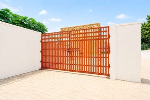 A gated entrance with a metal gate and a decorative panel. - Classic Ummed Palace (Mathura)