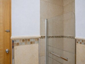 A shower with a glass door, a wooden door, and tiled walls. - 8-guest Malasana Central Suite (Madrid)