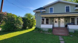 A two-story house with a front porch, a driveway, and a well-maintained lawn. - Pet-Friendly Duluth Basecamp Near Spirit Mountain (Duluth)