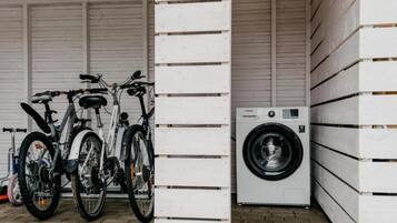 Un garaje con bicicletas y una lavadora.