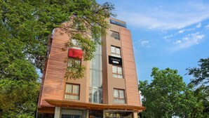 A multi-story building with a sign reading 'TOWNHOUSE' and 'Company Services.' - Suite La Casa Boutique Koramangala (Bengaluru)