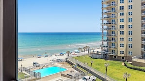 A high-rise hotel with a pool, beach view, and multiple balconies. - 🌴Amazing Ocean Views | Beachfront Pool | Oceanside Inn 605🌴 (Daytona Beach)