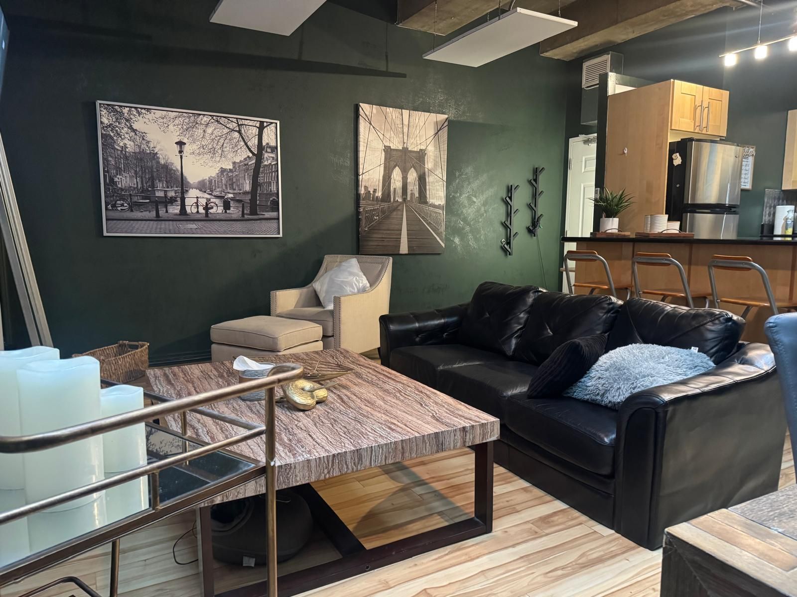 A modern living room with a sofa, a coffee table, and artwork on the wall.