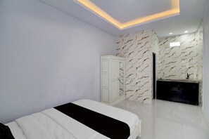 A bedroom with a bed, a wardrobe, and a vanity with a mirror. - Elegant Deluxe DBL Retreat Near Mangusada Hospital (Mengwi)