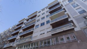 A multi-story building with balconies, large windows, and a modern architectural style. - 6-guest Haven Near Golden Mile (Madrid)