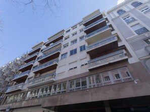 A multi-story building with balconies, large windows, and a modern architectural style. - 6-guest Haven Near Golden Mile (Madrid)