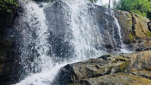 A waterfall cascading over rocks in a natural setting.