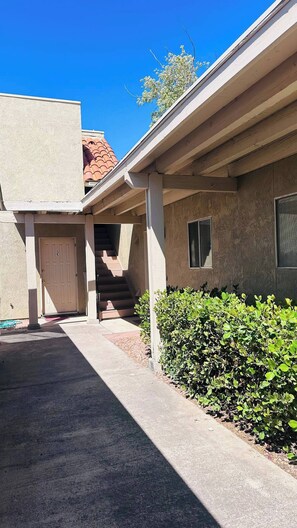 A building with a covered entrance, a door, and a window. - Tranquil Oasis Retreat. (Sierra Vista)