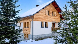 A wooden chalet with a sloped roof, stone foundation, and multiple windows. - Apartment - Le Batchu - Valloire - 12 guests (Valloire)