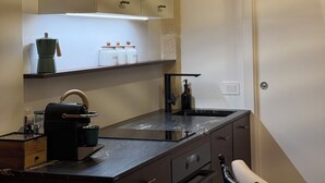 A modern kitchen with a built-in oven, a coffee machine, and a sink. - Angel Apartment 1 - Two Bedroom Apartment, Sleeps 4 (Monopoli)