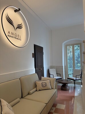 A modern living room with a sofa, chairs, a coffee table, and a large window with a view. - Angel Apartment 2 - One Bedroom Apartment, Sleeps 2 (Monopoli)