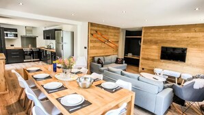 Een moderne woonruimte met een eetgedeelte, keuken en zithoek.