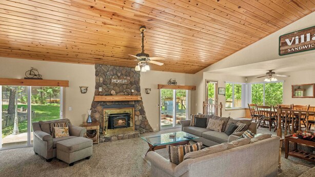 A spacious living room with a fireplace, a stone accent wall, and a sign reading 'Villa Sandwich.' - Walk to Snow Summit, AC, Fenced Yard (Big Bear Lake)