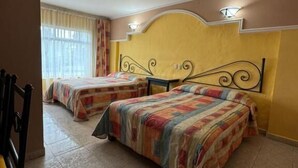 A hotel room with two beds, a chair, and a window with curtains. - HOTEL MEZVALL (Morelia)