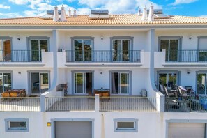A multi-story residential building with balconies, sliding glass doors, and a tiled roof. -  Loule Hill - Lua Villa (Faro)