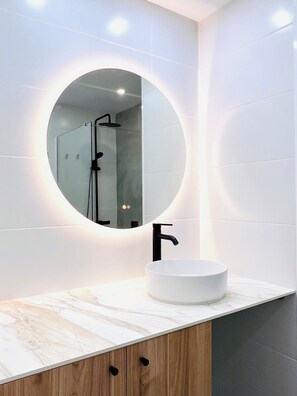 Shower, hair dryer, towels, toilet paper