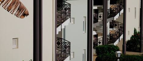 A modern building with multiple balconies and staircases.