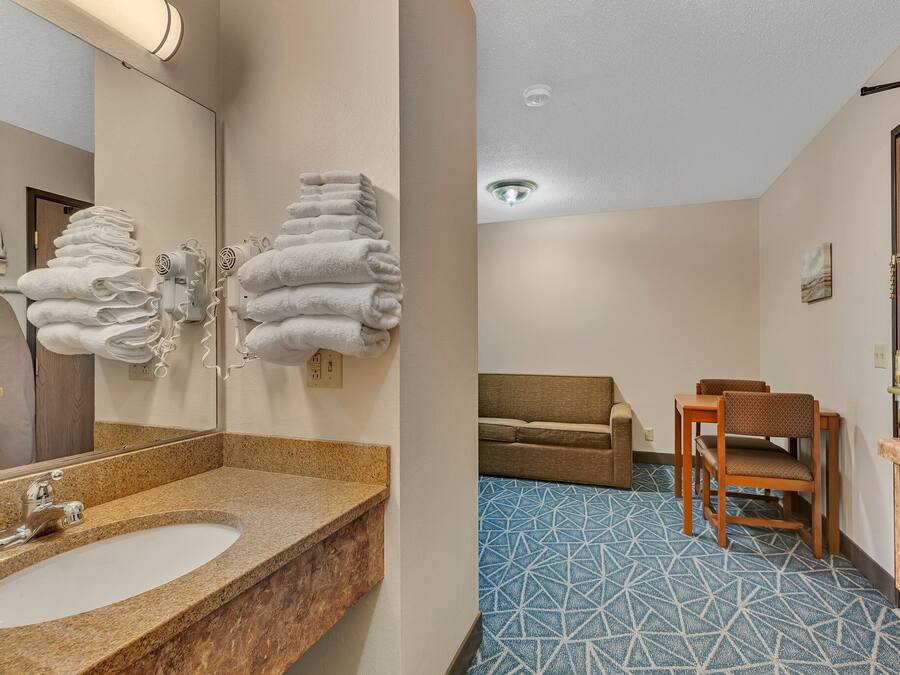 A bathroom with a sink, towel rack, and a mirror.