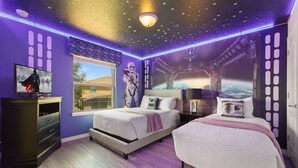 A bedroom with two beds, a TV, and a Star Wars-themed wall. - Last Minute Disney! Private Pool, Hot Tub & Themed Bedrooms. Book Now! #175501 (Orlando)