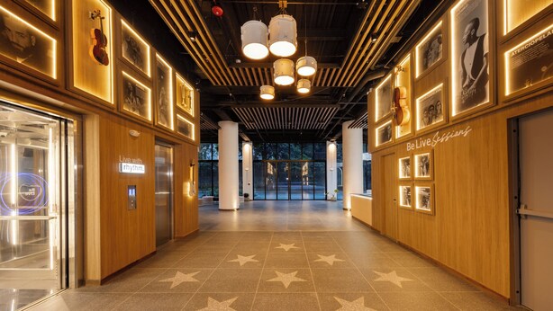 Un pasillo con piso estampado de estrellas, paredes de madera y cuadros enmarcados.