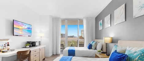 A hotel room with a bed, a desk, a chair, a TV, and a window with a city view.
