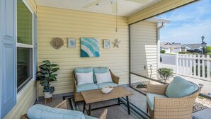A covered porch with a ceiling fan, a wicker sofa, a small table, and a potted plant. - WELCOME TO YOUR PIECE OF PARADISE (The Villages)