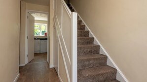 A hallway leading to a kitchen with a staircase. - Budget-Friendly Group Stay in Newport - Pass the Keys (Newport)