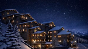 A multi-story lodge with balconies, snow-covered roofs, and a starry night sky. - Chalet Ouréa #102 - 6 guests - Ski-in - Ski-out (Les Allues)