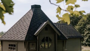 A small, single-story building with a gabled roof, a front door, and a nameplate reading 'Hare Hill.'