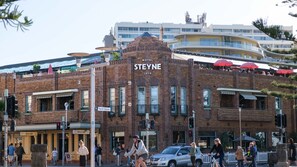A historic hotel with a prominent sign, a rooftop terrace, and a street-level bar. - Sandy Calm, Manly Walk to Beach, Corso & Ferry (Manly)
