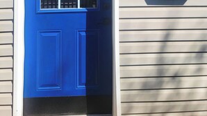 A blue door with a window, a mailbox, and a house number sign. - Stay in the heart of Toronto (toronto)