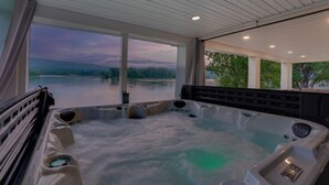 A hot tub with a view of a lake and mountains. - Riverfront Manor - Beautiful view and setting! (Dauphin)