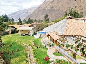 A rural property with a swimming pool, outdoor seating, and a view of mountains. - Luxury Retreat in the Holy Valley | Hot Tub, Mountain and Waterfall Views, Campfire   (Calca)