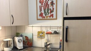 A kitchen with a sink, a toaster, a kettle, and a refrigerator. - Amici 13 Appartement/Fewo 2-Bettwohnung by Interhome (Saas-Fee)