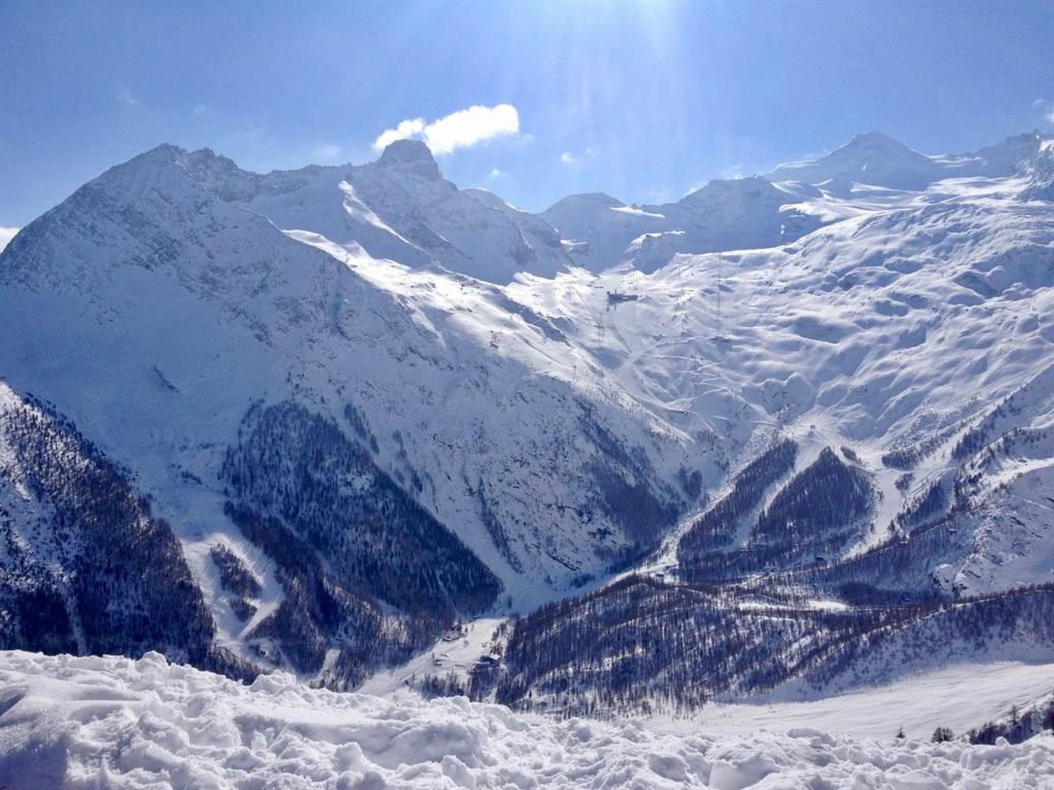 A snow-covered mountain landscape with clear skies.