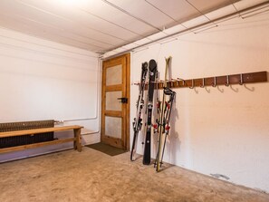 A ski storage room with a bench and skis mounted on a wall. - Chalet Bambi Appartement/Fewo 6-Bettwohnung Nr. 1 by Interhome (Saas-Fee)