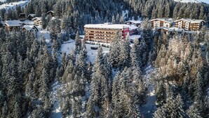 A snow-covered mountain resort with multiple buildings, including a large hotel with balconies. - Chalchboda 1 Appartement/Fewo, Dusche und Bad, WC, 7-Bettwohnung by Interhome (Arosa)