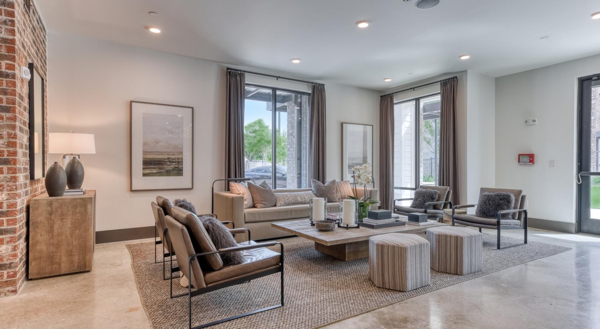 A spacious living room with a sofa, chairs, a coffee table, and a fireplace.