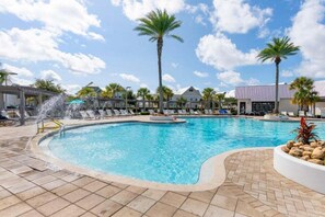 A swimming pool with lounge chairs and palm trees. - Luxury Prominence Retreat | Bikes, Resort Pool & Walk to The Big Chill (Watersound)