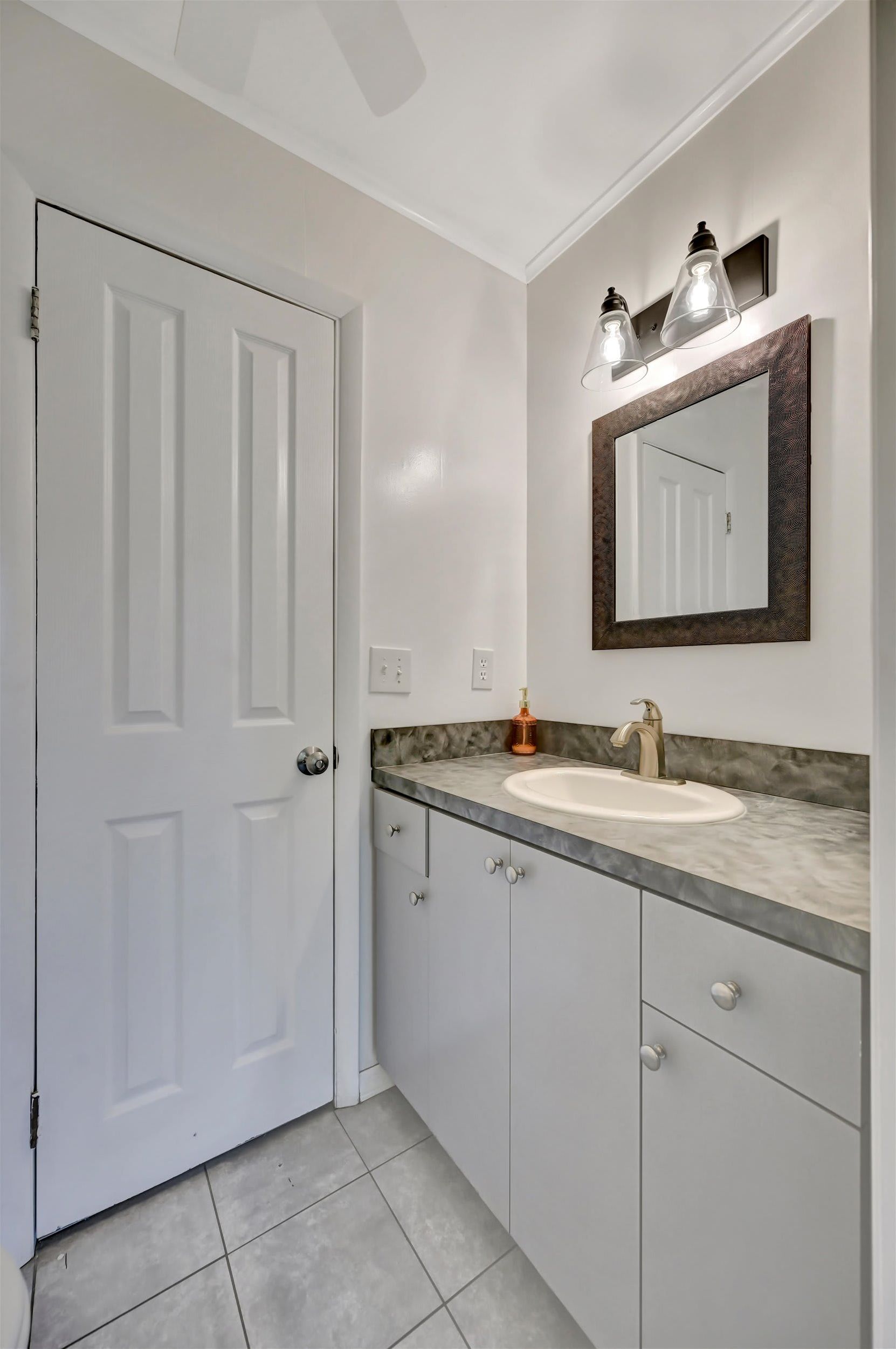 Your private bathroom is bright and clean, with a stylish framed mirror, modern lighting, and a sleek vanity—perfect for freshening up after your adventures.