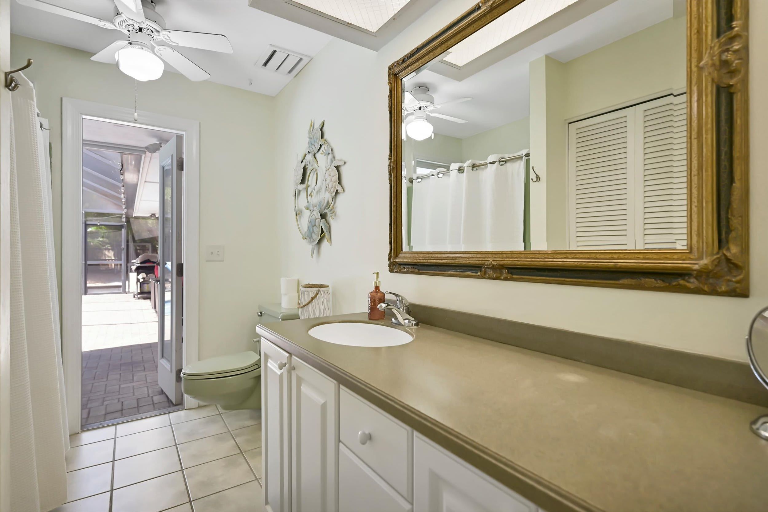 Your coastal-inspired bathroom offers a bright, airy escape with nautical touches and a skylight that bathes the space in natural light.
