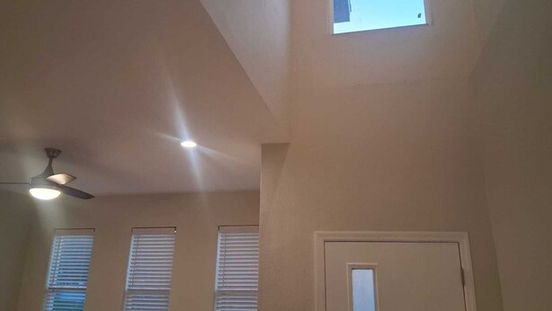 A room with a sloped ceiling, a ceiling fan, and three windows with blinds. - Serene 3-bedroom use in vibrant Orlando Close To Airport, Universal , Disney.... (Orlando)
