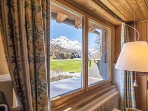 A room with a large window overlooking a snowy mountain landscape. - Residenz Soliva App. Viola by Interhome (Sils Maria)
