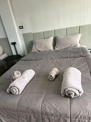 Family Quadruple Room, 2 Queen Beds, Non Smoking, Balcony | Down comforters, desk, laptop workspace, blackout drapes