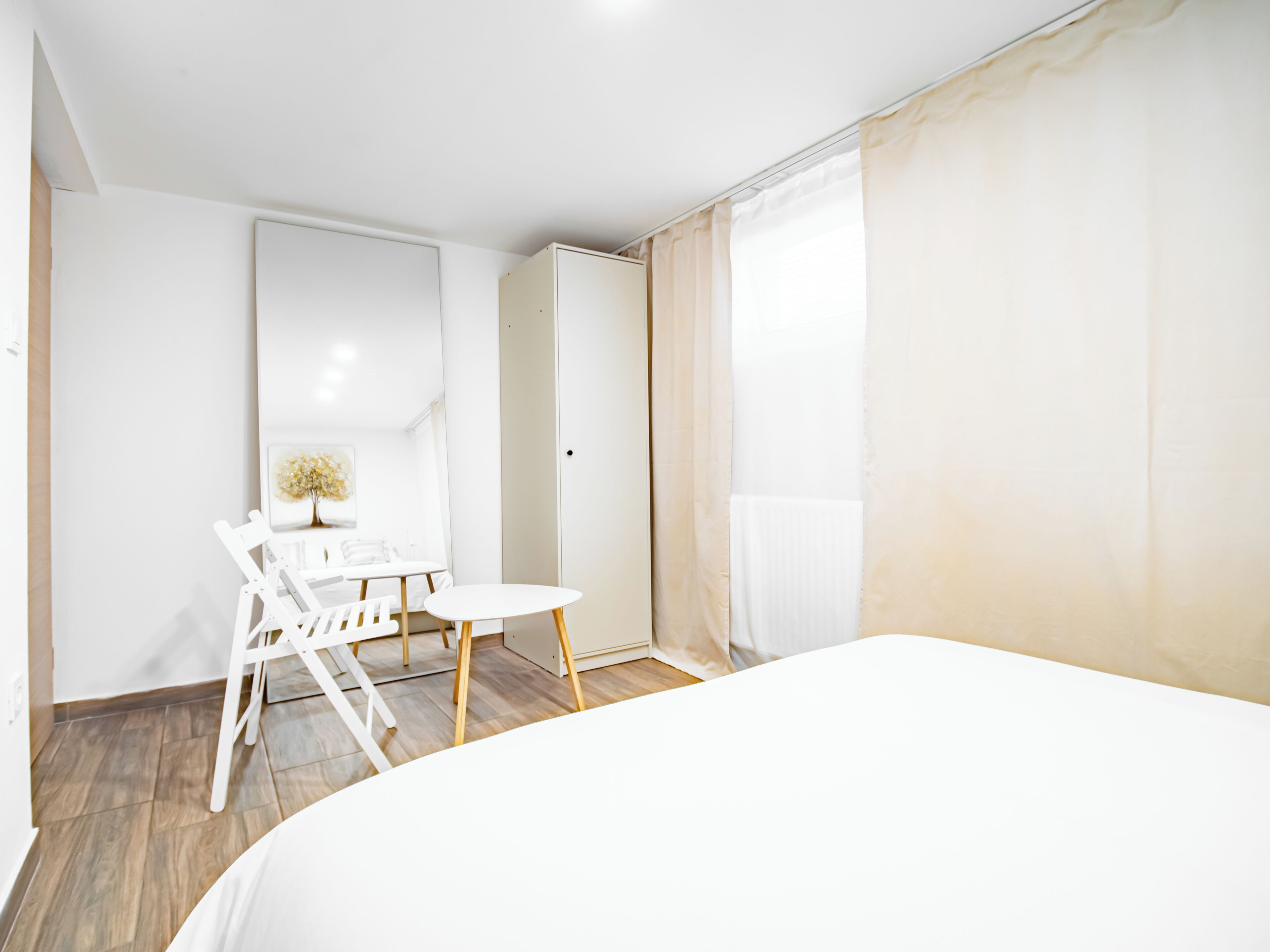 Un dormitorio con cama, escritorio y silla.