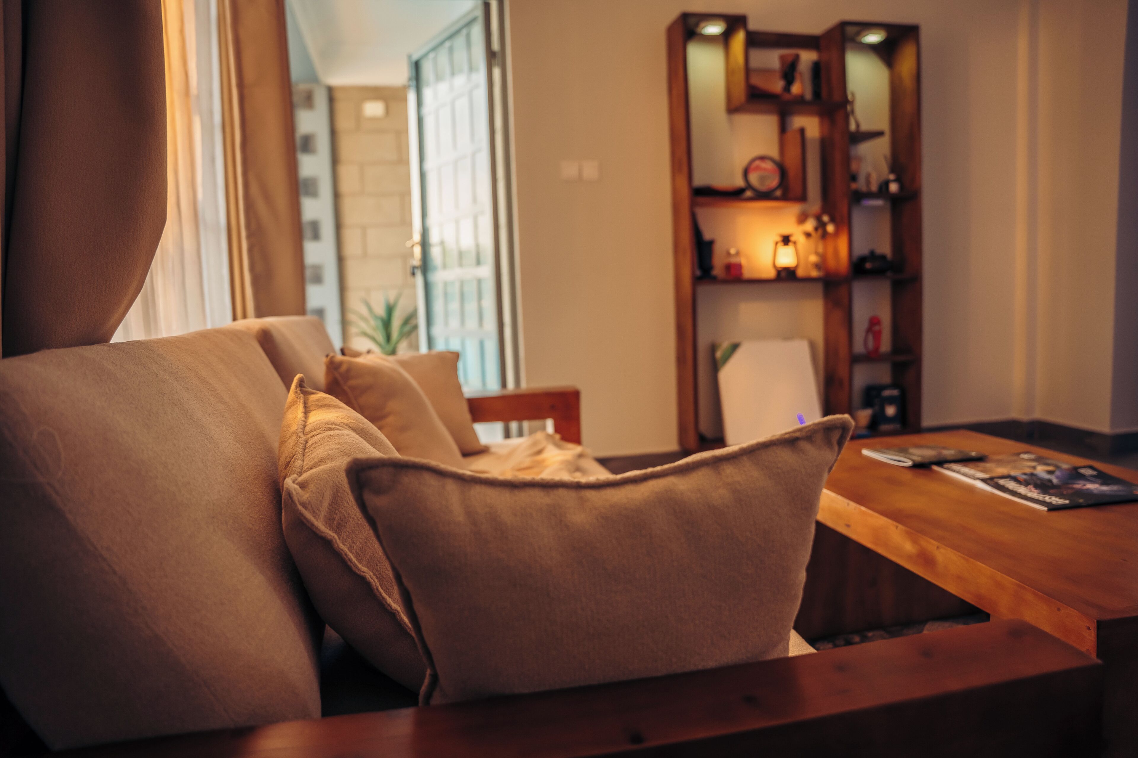 A cozy living area with a sofa, a wooden coffee table, and a bookshelf.