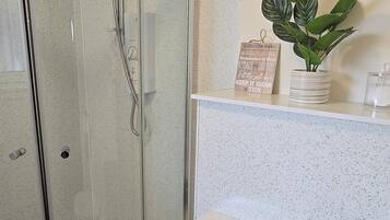 Shower, hair dryer, towels, toilet paper
