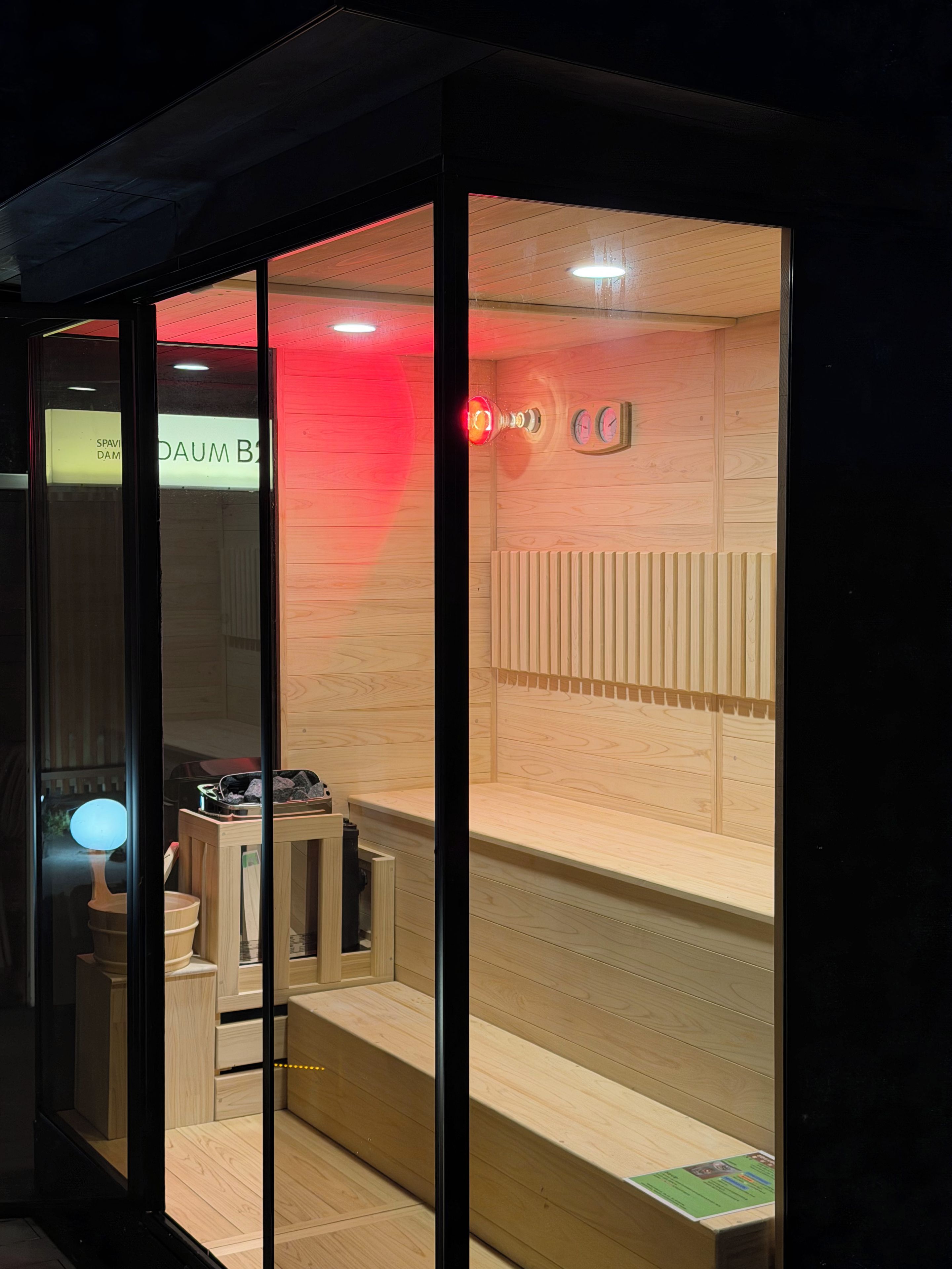A modern interior with a wooden floor, a reception desk, and a wall-mounted clock.